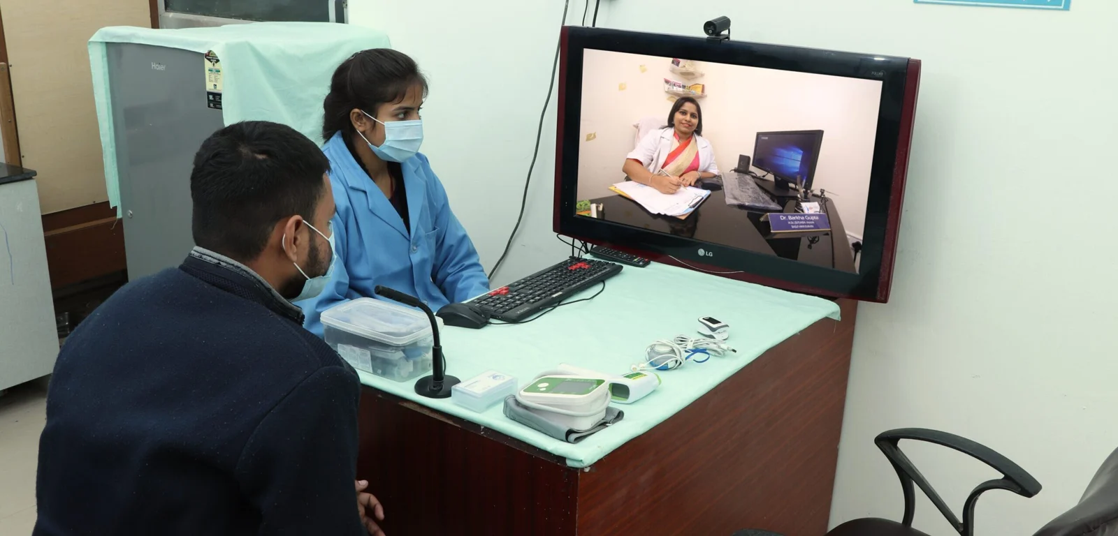 Patient and clinic assistant consulting a doctor by video at DrLaBike — original About Us photograph